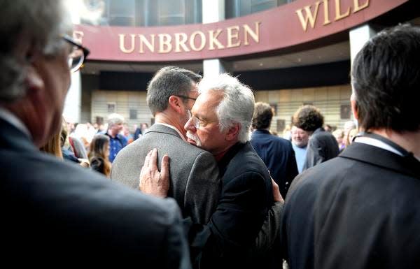 Singer Joe Bonsall gets a hug after a public announcement that the Oak Ridge Boys would be 2015 inductees into the Country Music Hall of Fame.