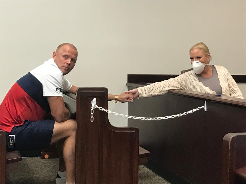 WWE Hall of Famer Tammy "Sunny" Sytch holds hands with her fiancé, James Pente, before her bond hearing on Friday, May 13, 2022, at the S. James Foxman Justice Center in Daytona Beach.