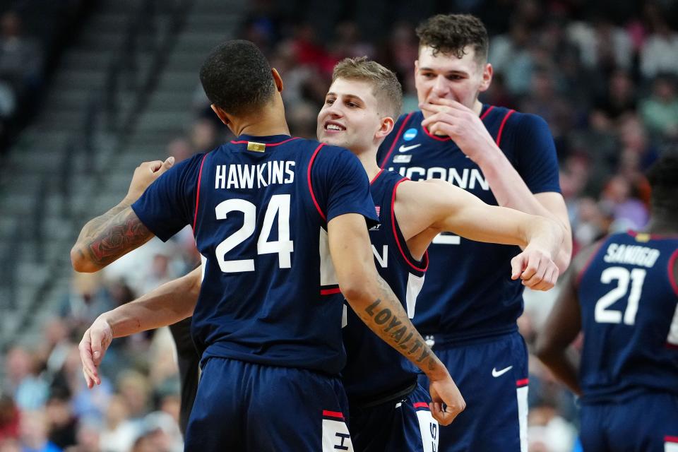 Connecticut guard Joey Calcaterra reacts with guard Jordan Hawkins (24) during the second half against Connecticut during the NCAA men's tournament West Regional final at T-Mobile Arena.