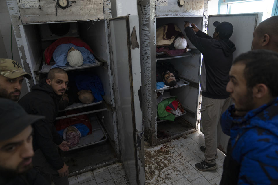 Mourners take the last look at the bodies of killed Palestinians ahead of their mass funeral in the West Bank city of Tulkarem, Friday, Jan. 19, 2024. The Israeli army withdrew early morning from the Tulkarem refugee camp after a 45 hours wide military operation in the refugee camp, the Israeli army said. Eight Palestinians were killed by the Israeli army during the Israeli army operation in the refugee camp, the Palestinian health ministry said. (AP Photo/Nasser Nasser)