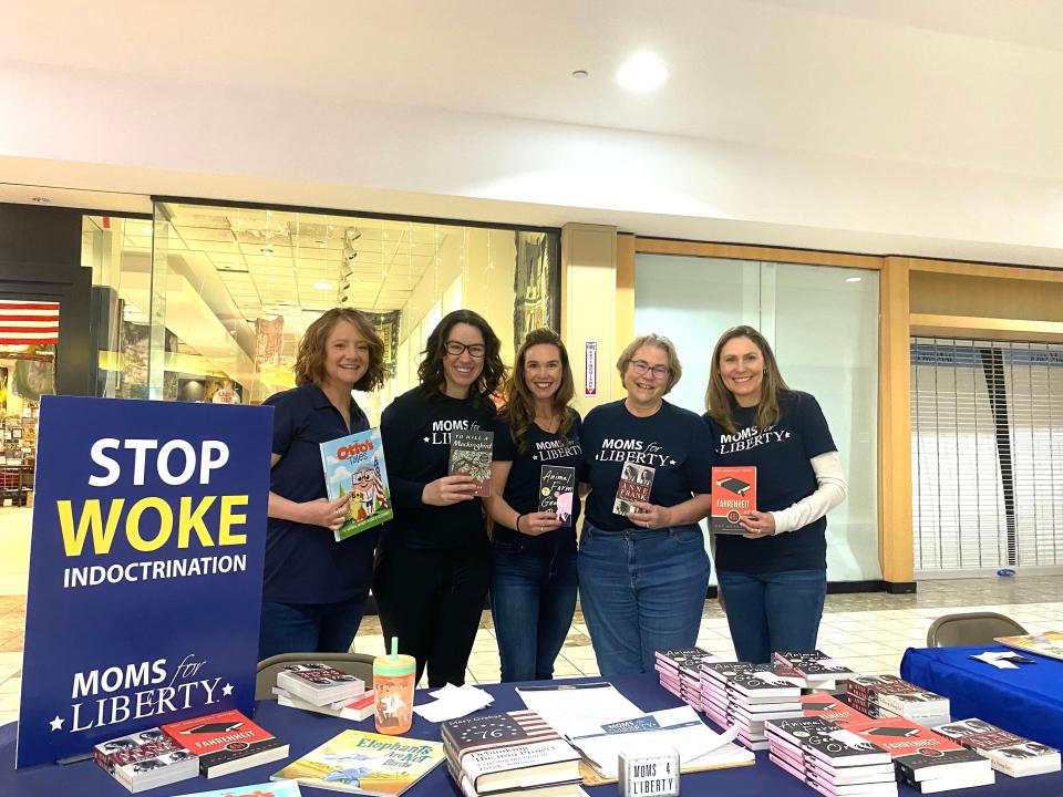 Moms for Liberty Carroll County chapter members hand out books to community members at an art event on March 29, 2024 to disprove its reputation that it supports sweeping book bans. From left, Kim Zentz, Beth Serio, Kit Hart, Sallie Taylor, and Shannon Hinkhaus.