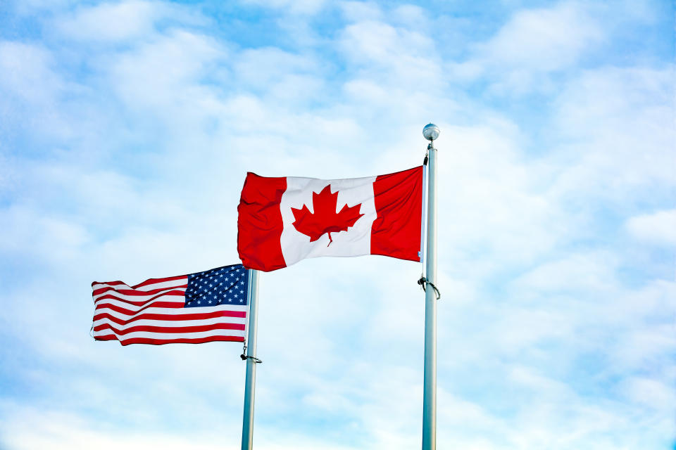 Canadian and American flag together, Canada flag forward in front