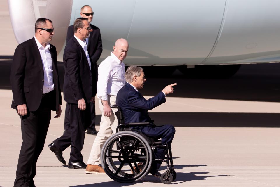 Department of Homeland Security chief, Alejandro Mayorkas, in white, walks along side Texas governor Greg Abbott after President Biden lands at El Paso International Airport aboard Air Force One Sunday, Jan. 8, 2023.