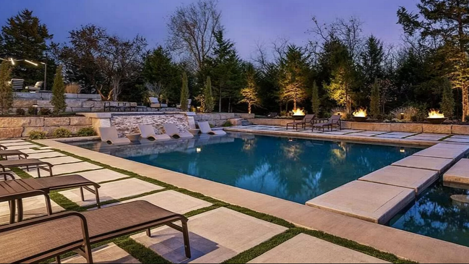 The outdoor pool at 7295 W. 183rd St. in Stilwell is in-ground and sits next to a putting green, sunken fire pit and walking trail.