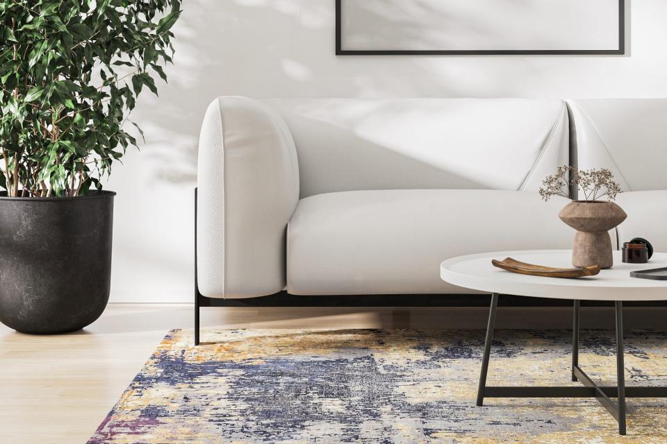 blue rug in neutral living room