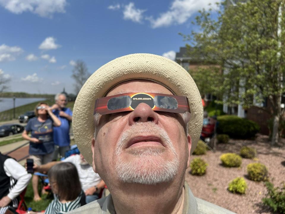 Henderson resident Gary Chapman takes a gaze at the partially eclipsed sun at 1:20 p.m. Monday. He and his wife, Sheryl, hosted a few dozen friends for an eclipse party in their front yard along Merritt Drive.