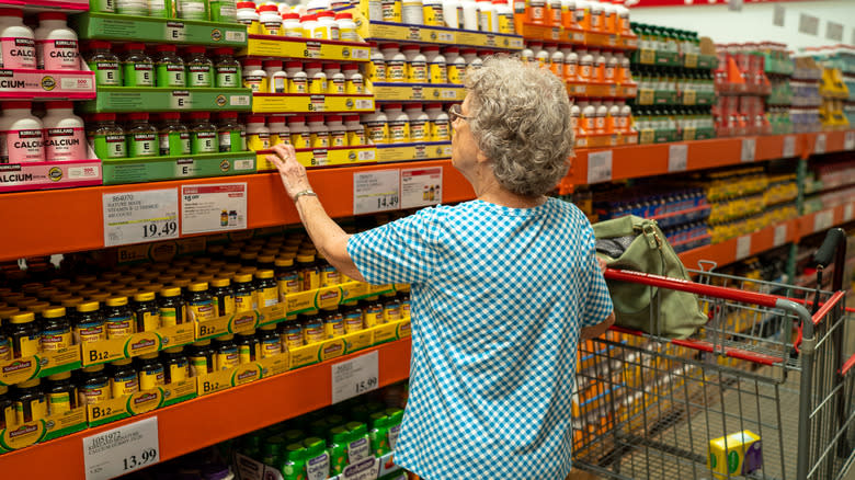 Woman examining items on shelves at Costco