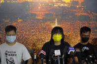 Chow Han Tung, vice chairwoman of the Hong Kong Alliance in Support of Patriotic Democratic Movements of China, center, and other group members attend a news conference in Hong Kong, Sunday, Sept. 5, 2021. The group behind the annual Tiananmen Square memorial vigil in Hong Kong said Sunday it will not cooperate with police conducting a national security investigation into the group's activities, calling it an abuse of power. (AP Photo/Kin Cheung)