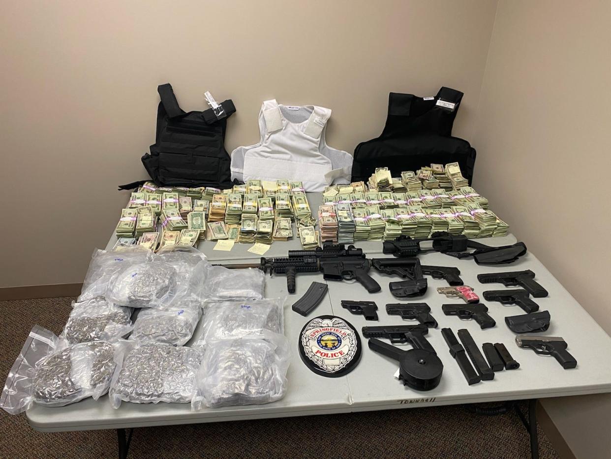 More than $500,000 in cash, marijuana, weapons and bulletproof vests were seized by authorities Tuesday in Springfield Township.