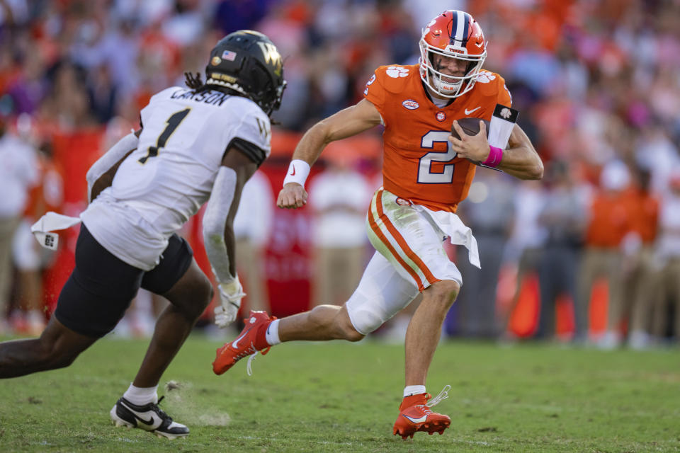 Wake Forest defensive back Caelen Carson (1) pursues Clemson quarterback Cade Klubnik (2) during the second half of an NCAA college football game Saturday, Oct. 7, 2023, in Clemson, S.C. (AP Photo/Jacob Kupferman)