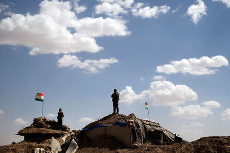 Kurdish Peshmerga fighters stand on an outpost at a defensive point near Sinjar, Iraq June 1, 2017. REUTERS/Alkis Konstantinidis