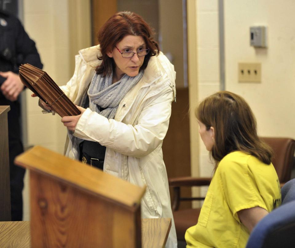 St. Clair Shores detective Sgt. Margaret Eidt, left, speaks with defendant Donna Scrivo at Scrivo's arraignment. at 40th District Court in St. Clair Shores, Mich. on Feb. 3, 2014. Scrivo is charged with mutilating and illegally removing a corpse after her 32-year-old son's body parts were found in bags along two rural roadways. (AP Photo/Detroit News, Robin Buckson) DETROIT FREE PRESS OUT; HUFFINGTON POST OUT