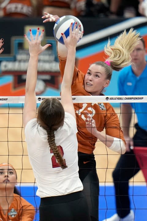 Texas’s Jenna Wenaas (13) spikes the ball past Nebraska’s Bergen Reilly (2) during the championship match in the NCAA Division I women’s college volleyball tournament Sunday, Dec. 17, 2023, in Tampa, Fla. (AP Photo/Chris O’Meara)