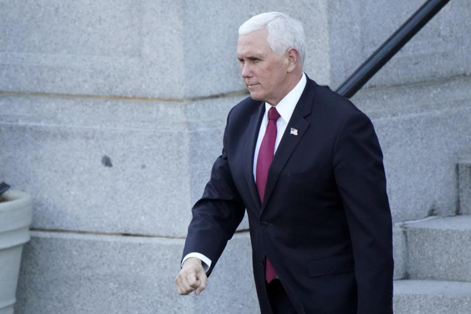 Vice President Mike Pence walks to the West Wing of the White House after addressing staff on the steps of the Eisenhower Executive Office Building, in the White House complex, Tuesday, Jan. 19, 2021, in Washington. (AP Photo/Gerald Herbert)