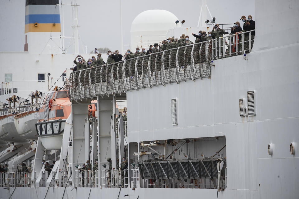 USNS Naval Hospital Ship Comfort personnel line the decks as they depart via the Hudson River, Thursday, April 30, 2020, in the Manhattan borough of New York. (AP Photo/John Minchillo)