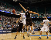 GREENSBORO, NC - MARCH 18: Tu Holloway #52 of the Xavier Musketeers goes up for a shot against Jordan Hamilton #44 and John Adams #4 of the Lehigh Mountain Hawks in the second half during the third round of the 2012 NCAA Men's Basketball Tournament at Greensboro Coliseum on March 18, 2012 in Greensboro, North Carolina. (Photo by Mike Ehrmann/Getty Images)