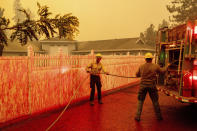 Firefighters engage in structure defense as the Dixie Fire burns in Chester, Calif., on Wednesday, Aug. 4, 2021. The region is under red flag fire warnings due to dry, windy conditions. (AP Photo/Noah Berger)