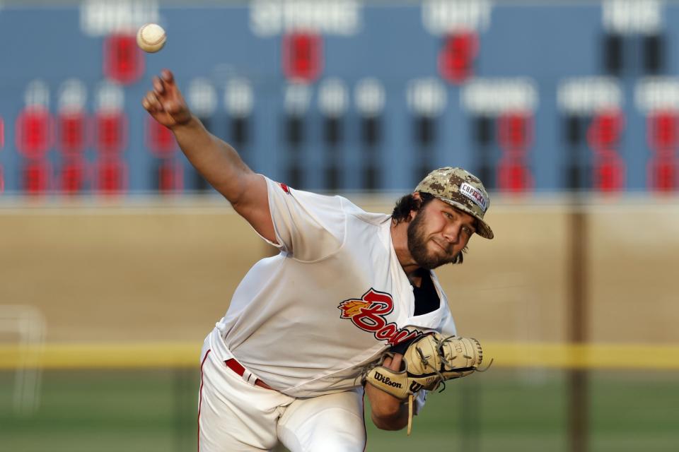 Bourne Braves' Bryce Cunningham pitches during a Cape Cod League baseball game against the Chatham Anglers, Wednesday, July 12, 2023, in Bourne, Mass. For 100 years, the Cape Cod League has given top college players the opportunity to hone their skills and show off for scouts while facing other top talent from around the country. (AP Photo/Michael Dwyer)