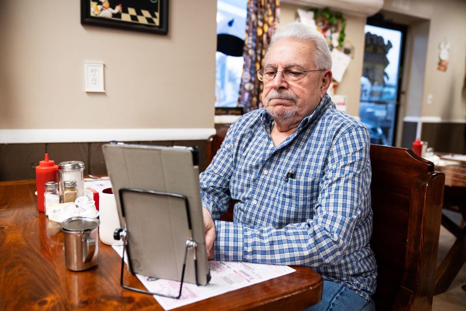 Anthony Milidantri, a retired electrician, plays word games as he sits for breakfast at LoriÕs Corner Kitchen in Ariel, PA.on March 28, 2024.