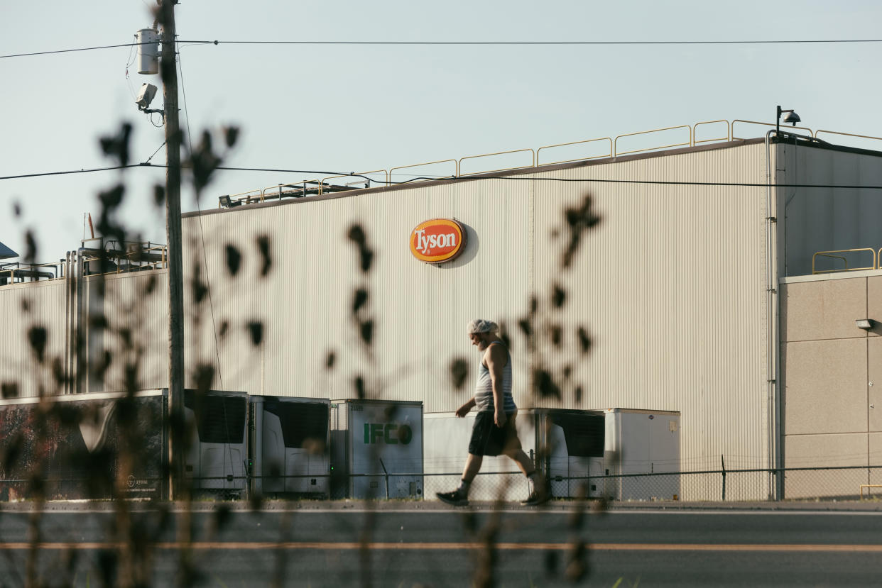 A worker walks along the highway past the Tyson poultry plant in Noel, Mo. (Chase Castor for NBC News)