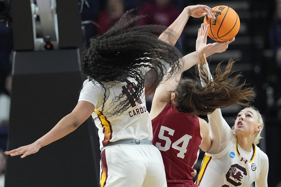 South Carolina center Kamilla Cardoso (10) and forward Chloe Kitts (21) block a shot attempt by Indiana forward Mackenzie Holmes (54) during the first half of a Sweet Sixteen round college basketball game during the NCAA Tournament, Friday, March 29, 2024, in Albany, N.Y. (AP Photo/Mary Altaffer)