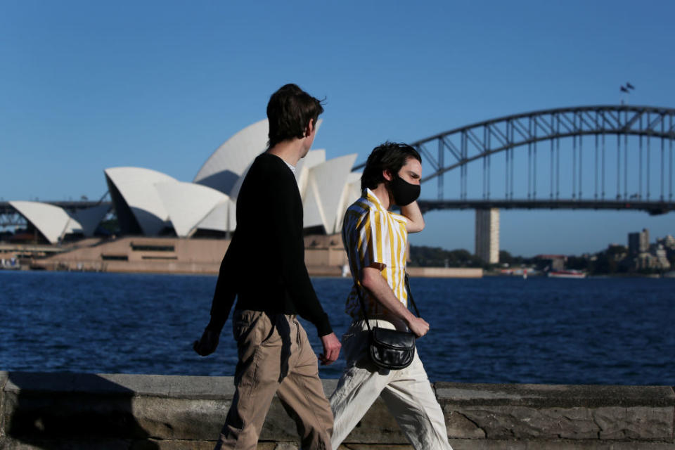 People are seen exercising along the Sydney Harbour shorefront in Sydney, Australia. 