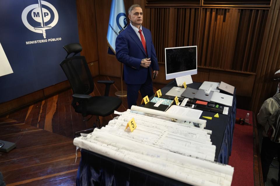 FILE - General Attorney Tarek William Saab stands over items he presents as evidence related to the arrest of human rights lawyer and activist Rocío San Miguel, accused of allegedly plotting to kill President Nicolas Maduro, in Caracas, Venezuela, Feb. 19, 2024. San Miguel is among the dozens of people taken into custody earlier in 2024 over accusations stemming from alleged plots against Maduro and his inner circle. (AP Photo/Ariana Cubillos, File)