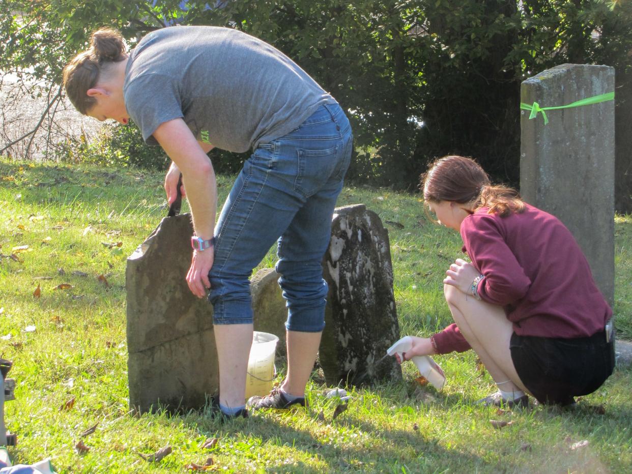 Kristine Pargeon, left, and her daughter Stella volunteered at the annual headstone cleanup at the cemetery for the first time this year.