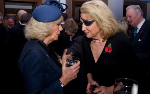 Camilla, Duchess of Cornwall (L), speaks with Marie Colvin of The Sunday Times (R) during a service at St. Bride's Church  - Credit: Getty