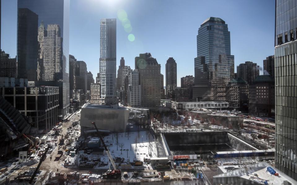 A view from 7 World Trade Center shows ongoing construction at the World Trade Center site on Friday Jan. 24, 2014, in New York. After years of delays due to funding disputes, engineering challenges and a nearly disastrous flood, a museum dedicated to victims of the 9/11 terror attacks will open to the public in mid-May in a giant cavern beneath the World Trade Center site — with a world-class admissions price of $24. (AP Photo/Bebeto Matthews)