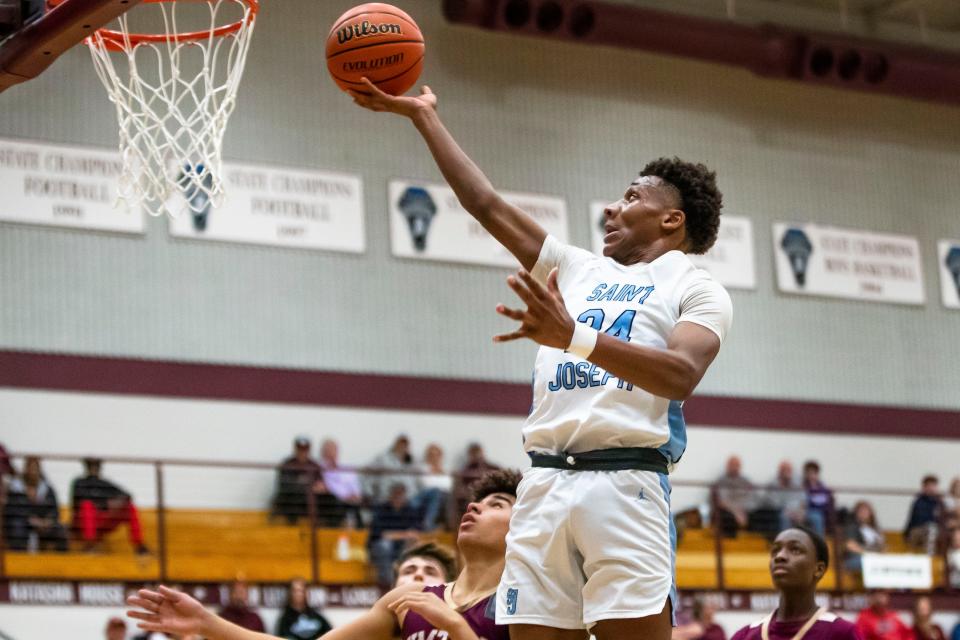 Saint Joseph's Jayce Lee (24) drives to the basket during the Saint Joseph vs. Jimtown sectional basketball game Tuesday, Feb. 28, 2023 at Jimtown High School in Elkhart.