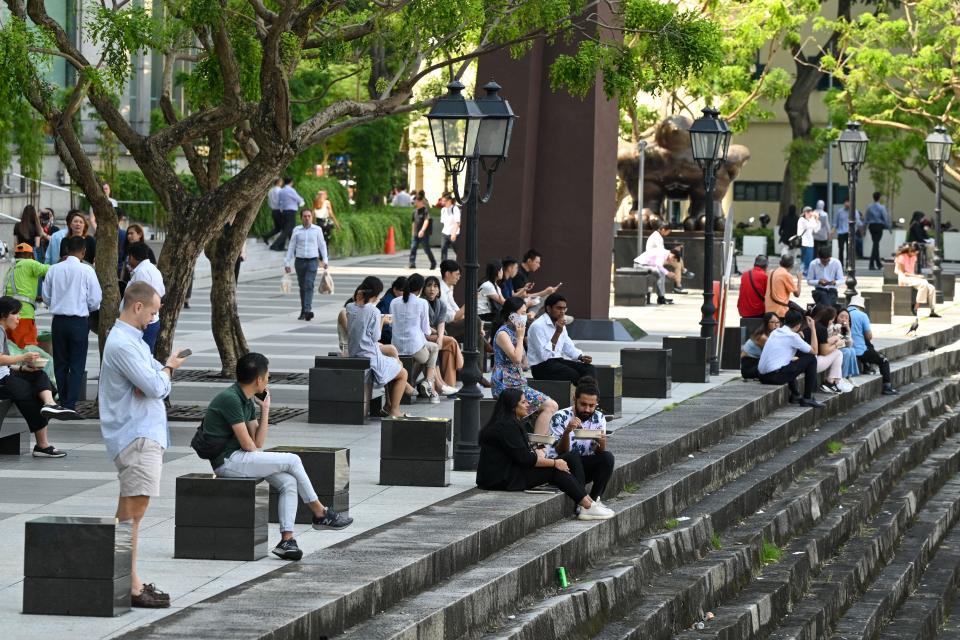 Workers at Raffles Place, illustrating a story on CPF changes.