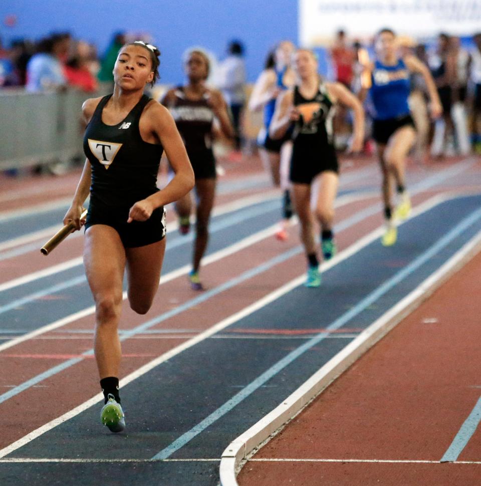 Tatnall's Kayla Woods crosses the finish line first in the 4x200 relay during the 2017 DIAA state indoor track and field championships in Landover, Md.