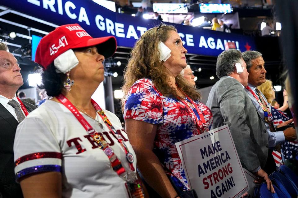 Delegates wear ear coverings to stand is solidarity with former President Donald Trump after a failed assassination attempt.