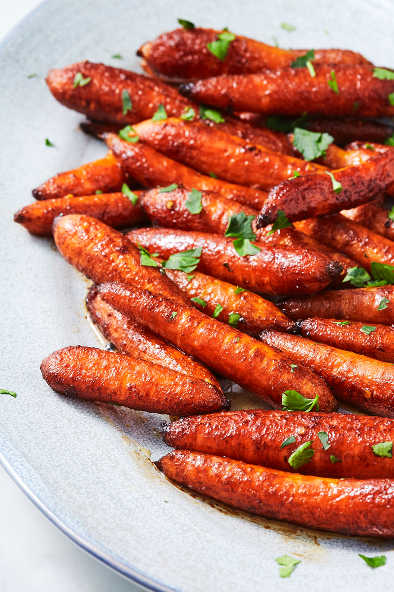 <p>Sometimes we find ourselves with a bag of baby carrots and we aren't sure what to do with them. This is what we should do. Roasting baby carrots in a maple-balsamic glaze will turn everyone into a carrot lover! </p><p>Get the <a href="https://www.delish.com/uk/cooking/recipes/a31011761/roasted-baby-carrots-recipe/" rel="nofollow noopener" target="_blank" data-ylk="slk:Balsamic Roasted Baby Carrots;elm:context_link;itc:0;sec:content-canvas" class="link ">Balsamic Roasted Baby Carrots</a> recipe.</p>