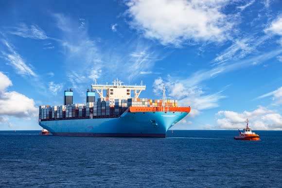 A tugboat towing a cargo ship to harbor.