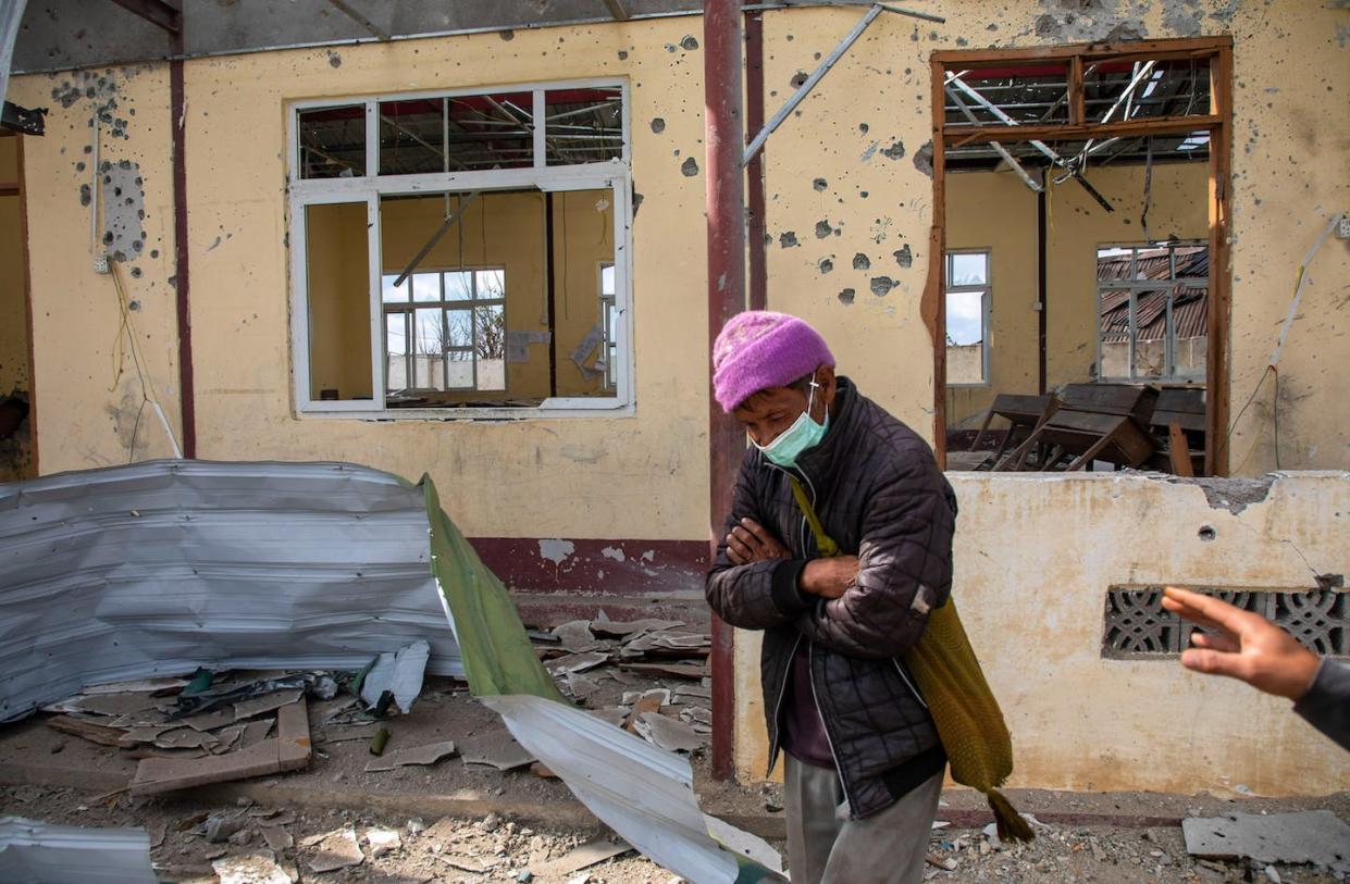 A village elder stands outside a school destroyed by aircraft fire in Shan State. <a href="https://www.gettyimages.com/detail/news-photo/village-elder-is-standing-in-front-of-the-village-school-news-photo/1246147334?adppopup=true" rel="nofollow noopener" target="_blank" data-ylk="slk:Mai Thomas/SOPA Images/LightRocket via Getty Images;elm:context_link;itc:0;sec:content-canvas" class="link ">Mai Thomas/SOPA Images/LightRocket via Getty Images</a>