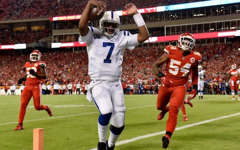 Indianapolis Colts quarterback Jacoby Brissett (7) scores a touchdown next to Kansas City Chiefs linebacker Damien Wilson (54) during the first half of an NFL football game in Kansas City - Credit: AP