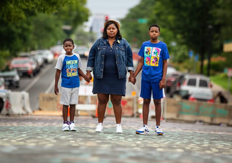 Alicia D. Smith and her two boys Walter Johnson III, 11, (right) and Alonzo Johnson III, 7, (left)