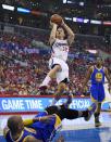 Los Angeles Clippers forward Blake Griffin, top, puts up a shot as he fouls Golden State Warriors forward Marreese Speights, below, while guard Jordan Crawford looks on during the first half in Game 1 of an opening-round NBA basketball playoff series, Saturday, April 19, 2014, in Los Angeles. (AP Photo/Mark J. Terrill)