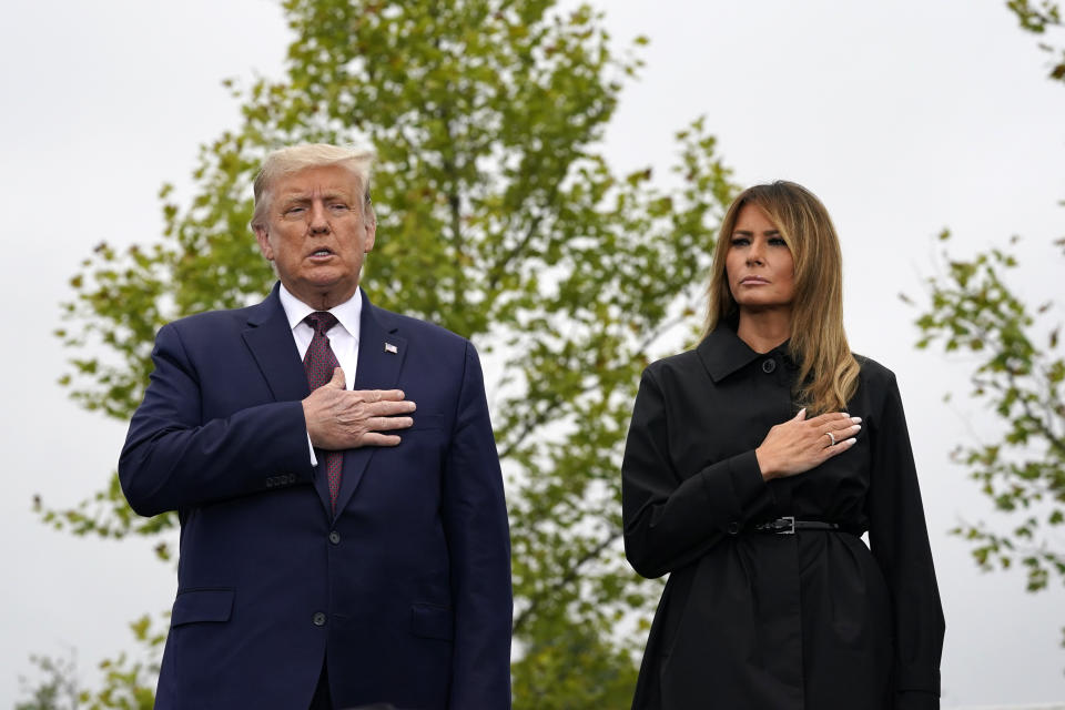 President Donald Trump and first lady Melania Trump stand during the Pledge of Allegiance at a 19th anniversary observance of the Sept. 11 terror attacks, at the Flight 93 National Memorial in Shanksville, Pa., Friday, Sept. 11, 2020. (AP Photo/Alex Brandon)