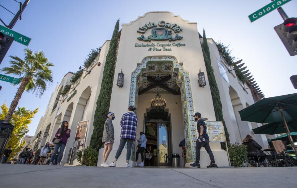 People wait in line to get in to Urth Caffe on Colorado Boulevard in Pasadena.