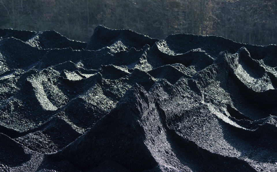 Hard coal is stored in the coal port of the Mehrum coal-fired power plant in the district of Peine in Hohenhameln, Germany, Wednesday, Jan. 15, 2020. ( Julian Stratenschulte/dpa via AP)