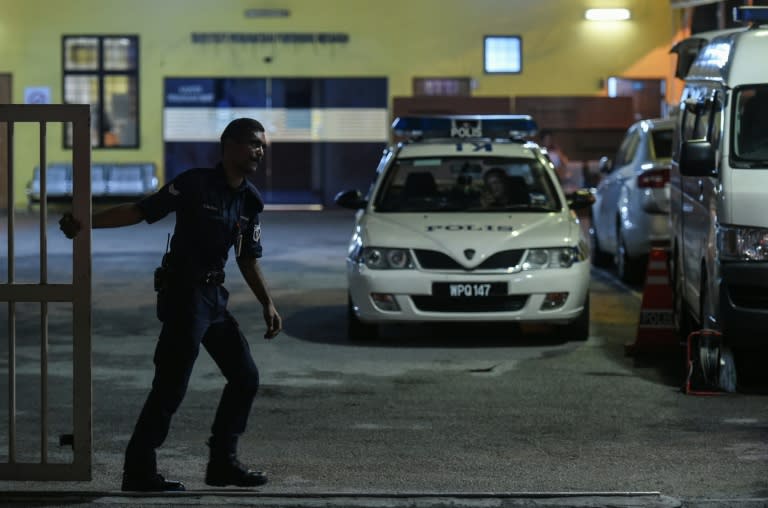 A Malaysian policeman closes the door of the forensics wing of the Hospital Kuala Lumpur where the body of Kim Jong-Nam, the half-brother of North Korean leader Kim Jong-Un, is being kept