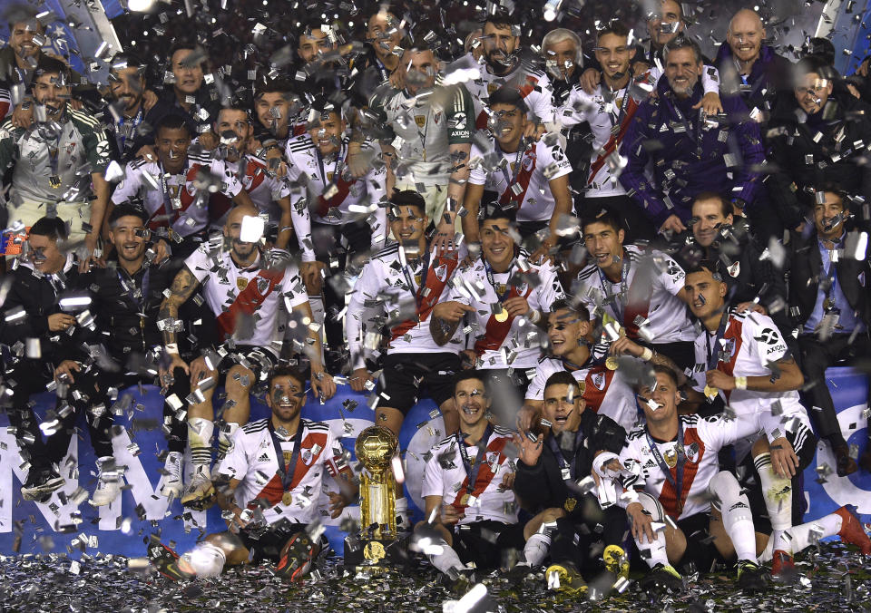 River Plate celebrates with their Recopa trophy amid confetti after defeating Brazil's Athletico Paranaense 3-0 at the Recopa Sudamericana final soccer match in Buenos Aires, Argentina, Thursday, May 30, 2019. (AP Photo/Gustavo Garello)