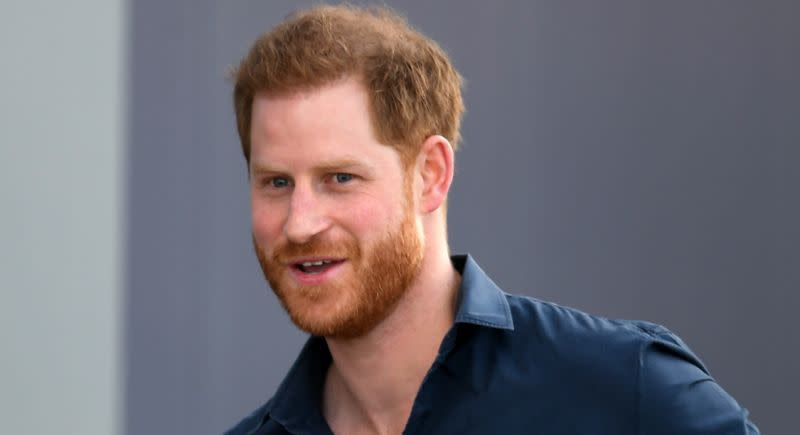 prince harry smiling at the camera