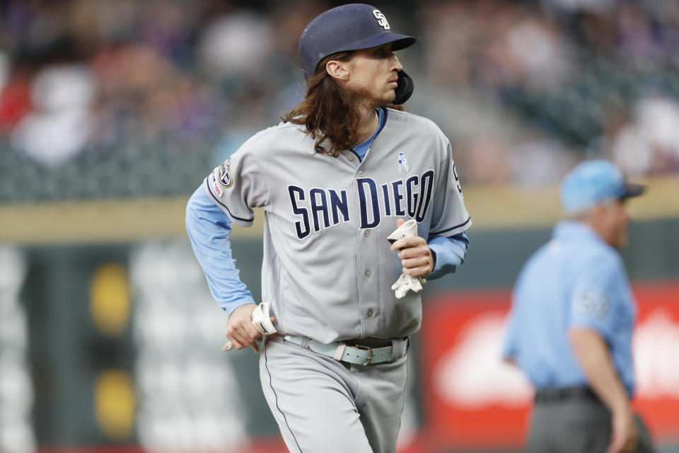 San Diego Padres pinch hitter Matt Strahm heads back to the dugout after drawing a walk with the bases loaded to force in the go-ahead run off Colorado Rockies relief pitcher Jon Gray in the ninth inning of a baseball game Sunday, June 16, 2019, in Denver. (AP Photo/David Zalubowski)