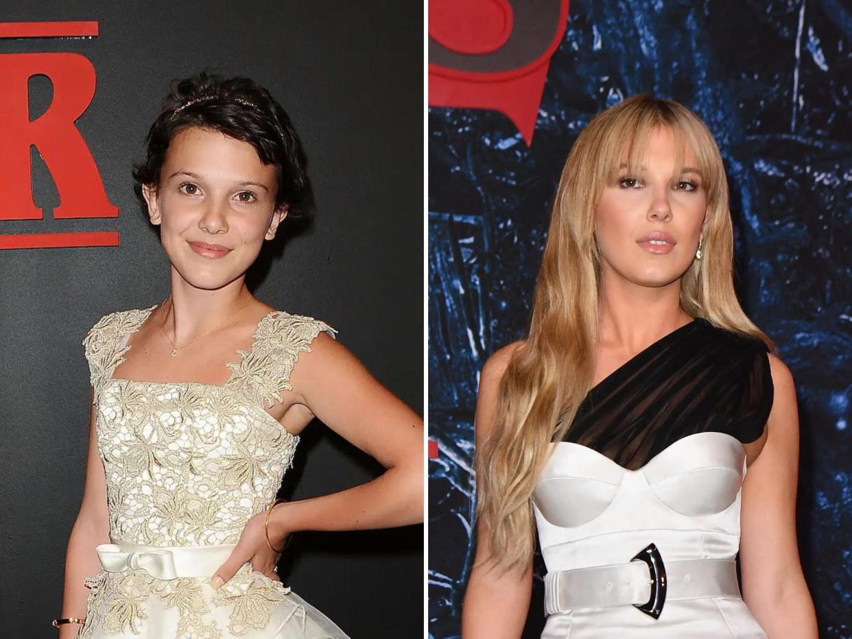 left: millie bobby brown, age 12, at the stranger things season one premier in 2016. she's wearing a white dress with gold detailing, her hair cropped short. she's smiling with one hand on her hip; right: millie bobby brown at age 18 at the stranger things season 4 premiere. she's wearing a white dress with a black fabric sleeve over one sholder, and her hair is worn long and blonde