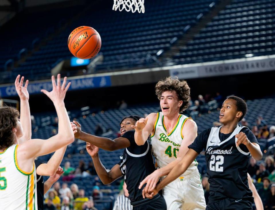 Richland’s Lucas Westerfield (40) bats out the ball from Kentwood’s Jaevieon Jamerson (13) and Kentwood’s Yusof Edey (22) during the quarterfinals game of the Class 4A state tournament at the Tacoma Dome, on Thursday, Feb. 29, 2024, in Tacoma, Wash.