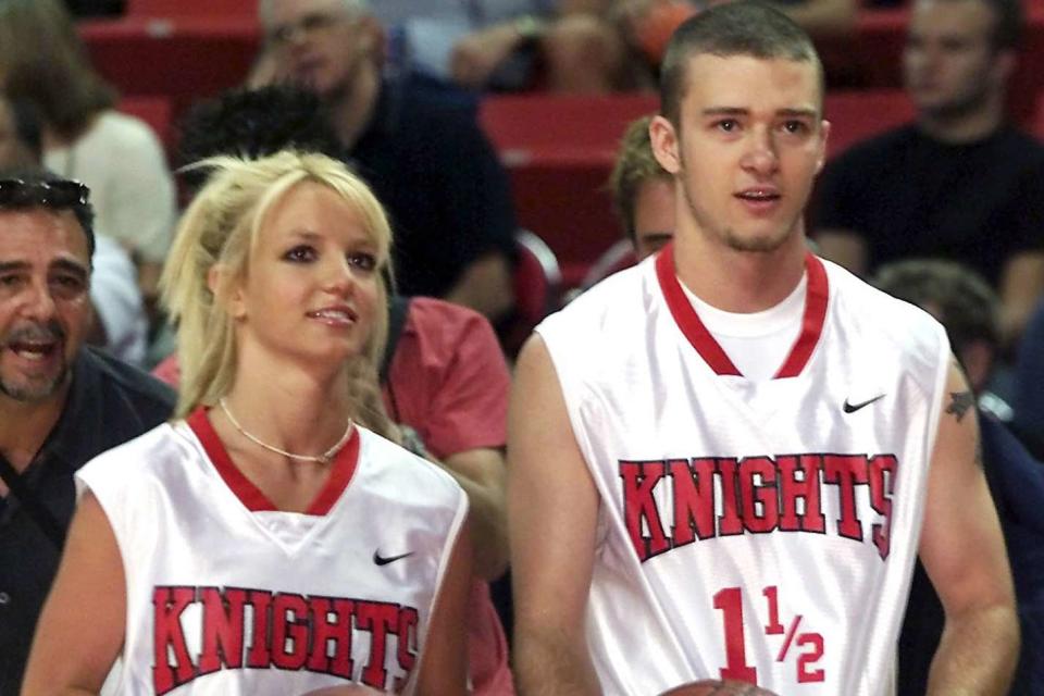 <p>Ethan Miller/Getty</p> Britney Spears (L) and Justin Timberlake (R) at a celebrity basketball game on July 29, 2001